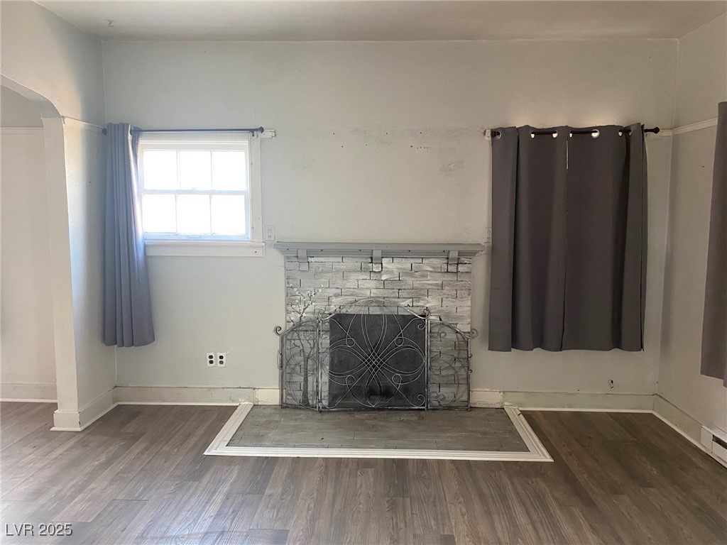 1001 Mill Street Ely, NV 89301 - Photo 4 of 18 Unfurnished living room featuring a stone fireplace and wood finished floors