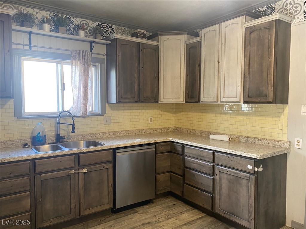 1001 Mill Street Ely, NV 89301 - Photo 6 of 18 Kitchen with tasteful backsplash, dishwasher, wood finished floors, and light countertops