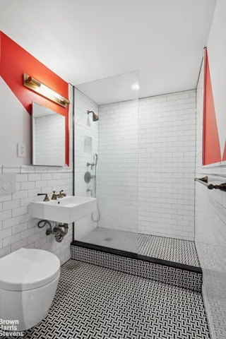 a bathroom with a sink toilet and shower