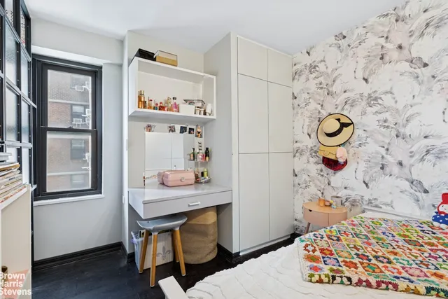 a bedroom with a bed and a table in it