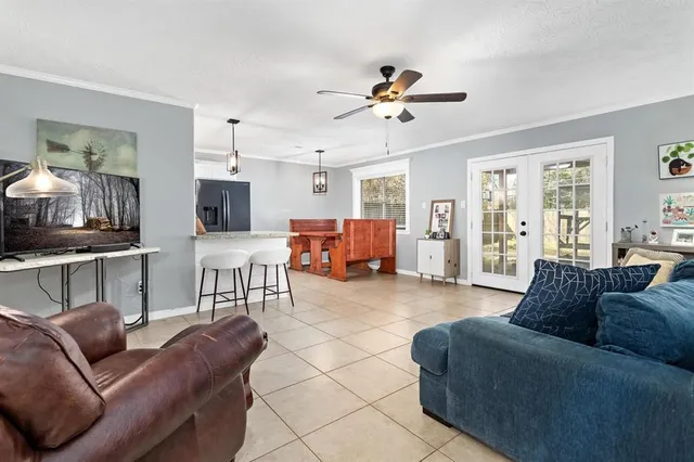 a living room with furniture and kitchen view