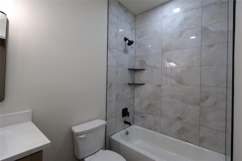106 Ute Trail Mabank, TX 75156 - Photo 16 of 28 Bathroom featuring vanity and washtub / shower combination