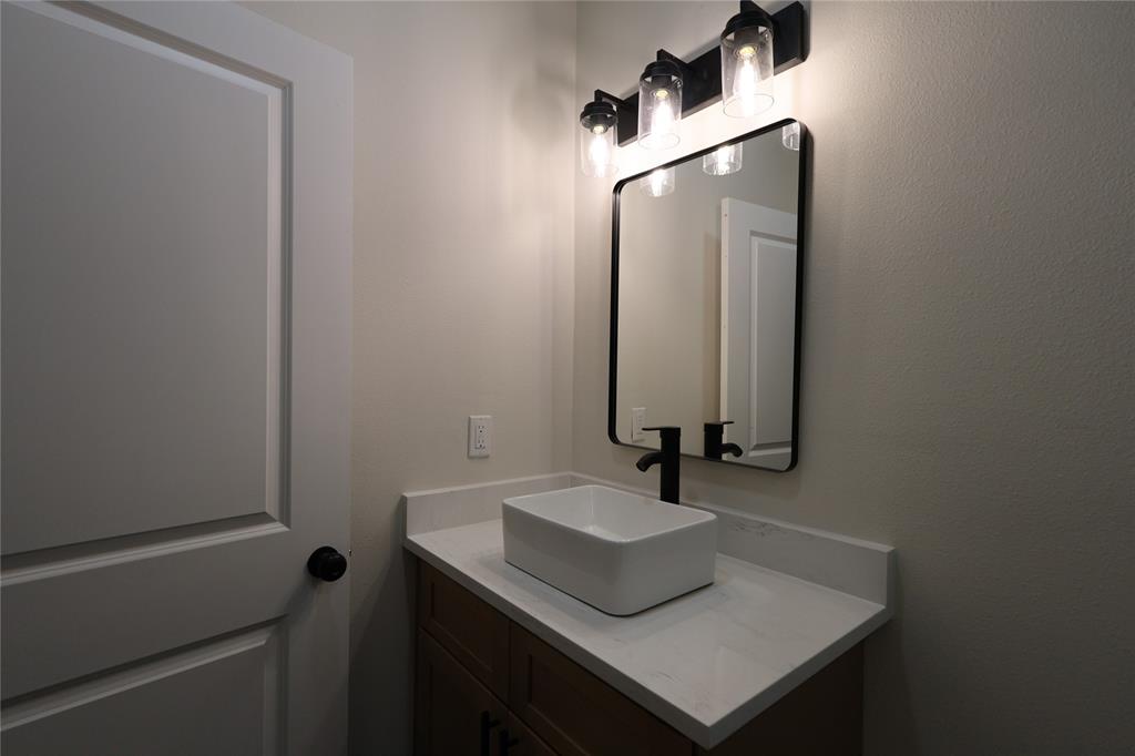 106 Ute Trail Mabank, TX 75156 - Photo 17 of 28 Bathroom featuring vanity and a textured wall