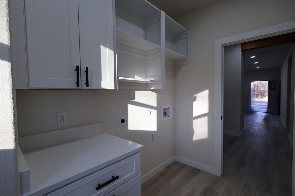 106 Ute Trail Mabank, TX 75156 - Photo 20 of 28 Laundry area with washer hookup, hookup for an electric dryer, light wood-style flooring, cabinet space, and recessed lighting