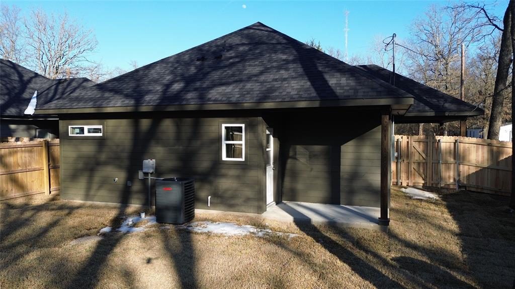 106 Ute Trail Mabank, TX 75156 - Photo 21 of 28 Rear view of house with a fenced backyard, a shingled roof, and a gate