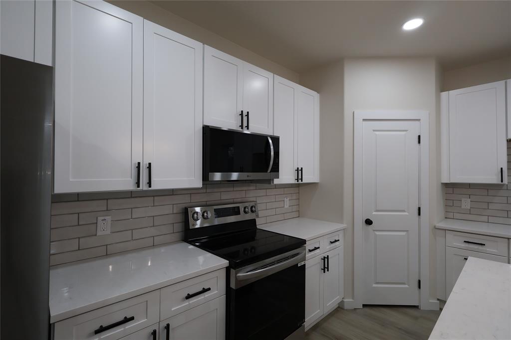 106 Ute Trail Mabank, TX 75156 - Photo 5 of 28 Kitchen with stainless steel appliances, white cabinets, backsplash, and recessed lighting