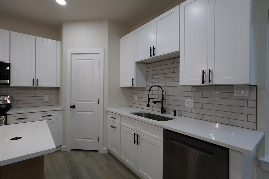 106 Ute Trail Mabank, TX 75156 - Photo 7 of 28 Kitchen featuring stainless steel appliances, white cabinets, light stone counters, light wood finished floors, and recessed lighting