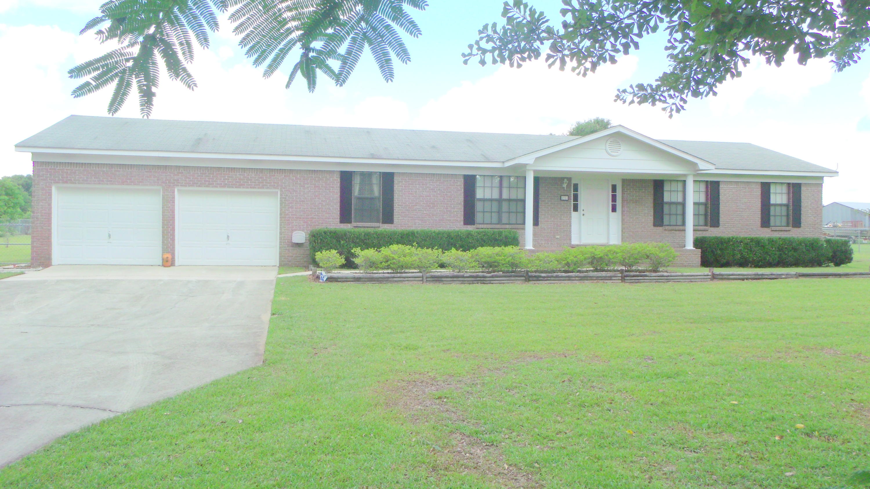 5918 Jack Stokes Road Baker, FL 32531 - Photo 1 of 23 a front view of a house with a garden