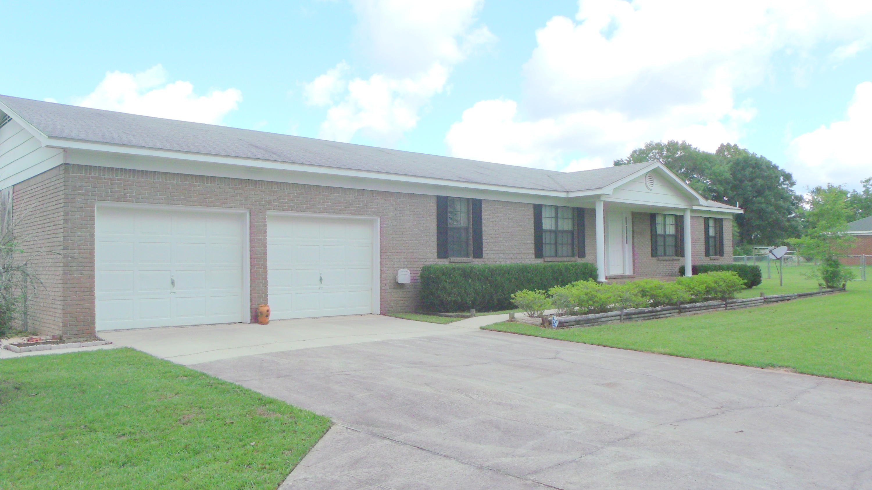 5918 Jack Stokes Road Baker, FL 32531 - Photo 2 of 23 a front view of a house with a yard and garage