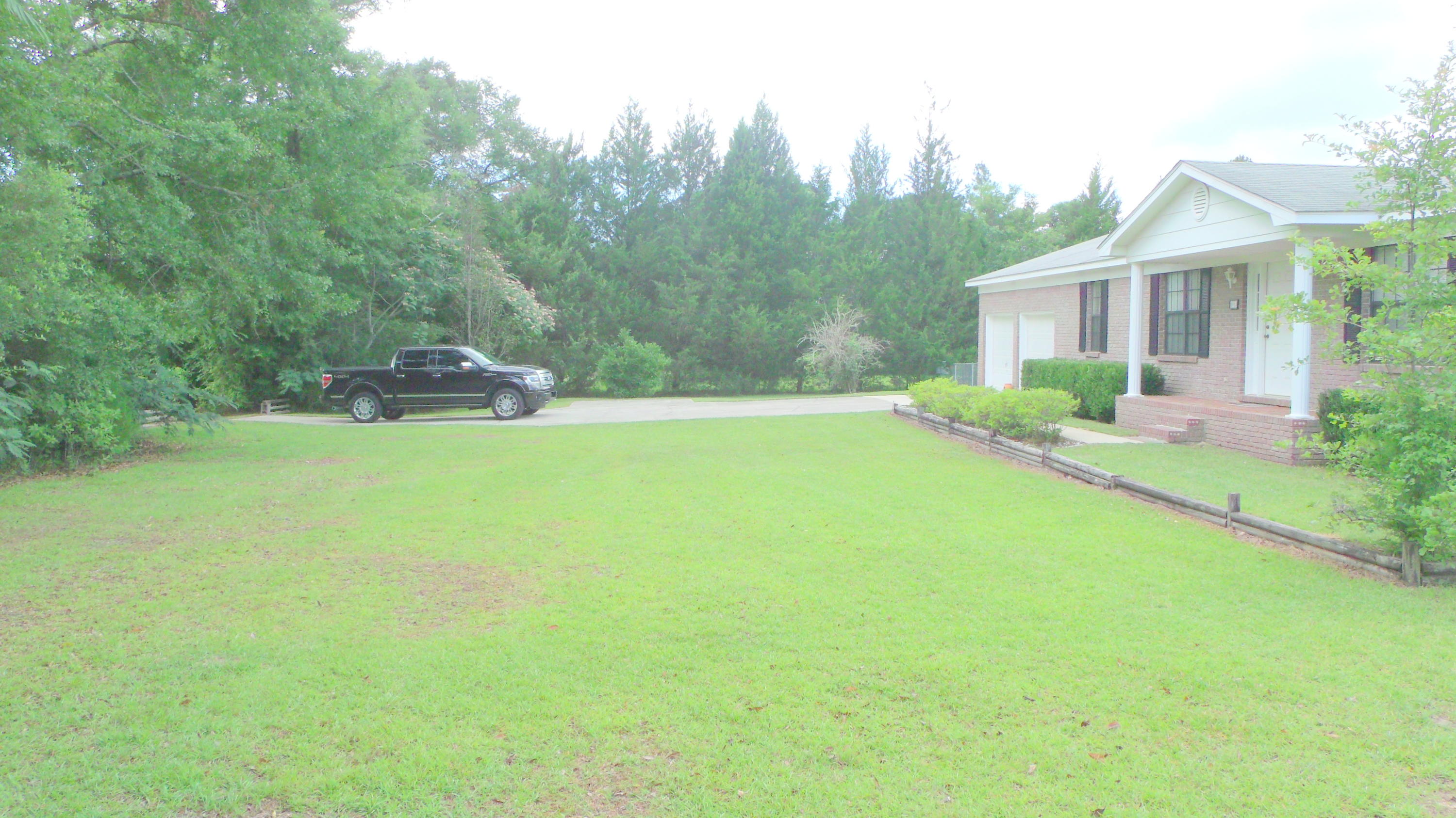 5918 Jack Stokes Road Baker, FL 32531 - Photo 4 of 23 a view of a house with a yard and sitting area