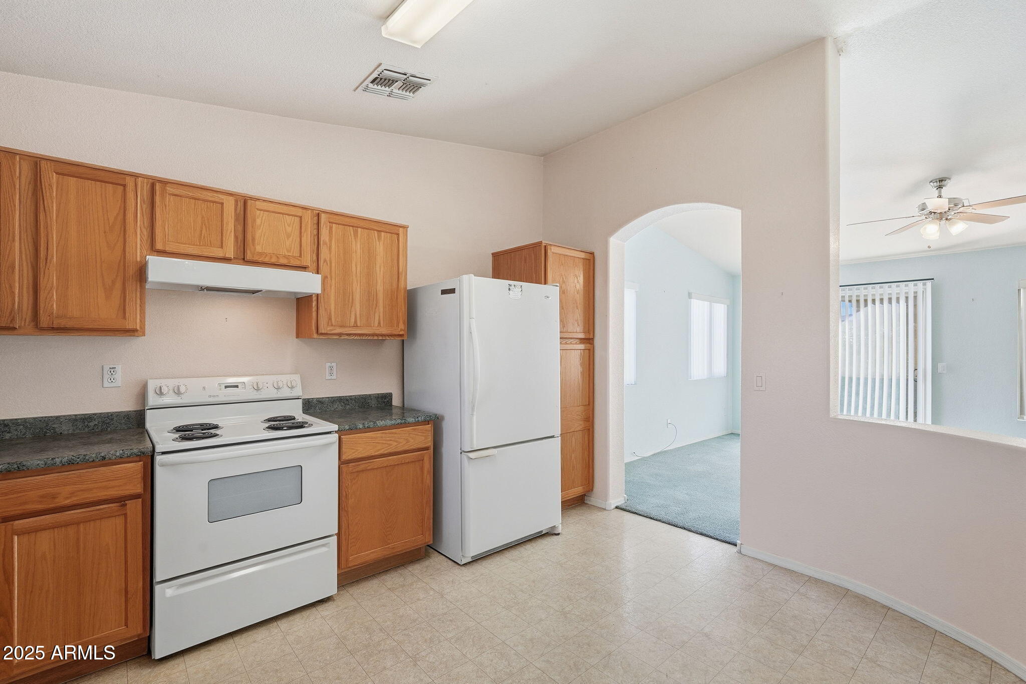 2101 South Meridian Road, Unit 354 Apache Junction, AZ 85120 - Photo 11 of 50 a kitchen with a stove a sink and a refrigerator