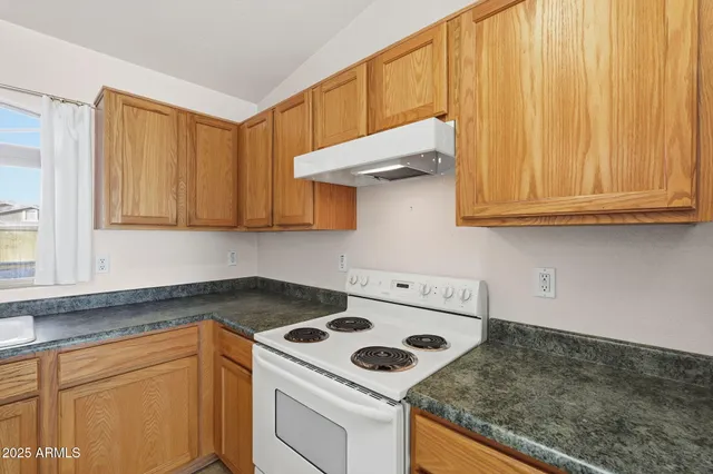 a kitchen with a stove and a sink