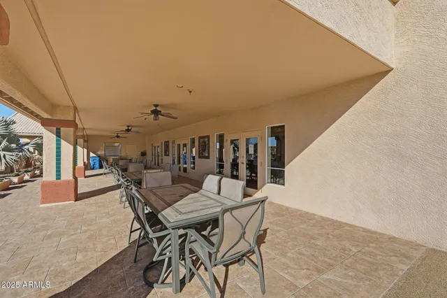 a view of a terrace with chairs and potted plants