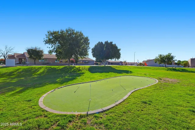 a view of a tennis ground with large trees