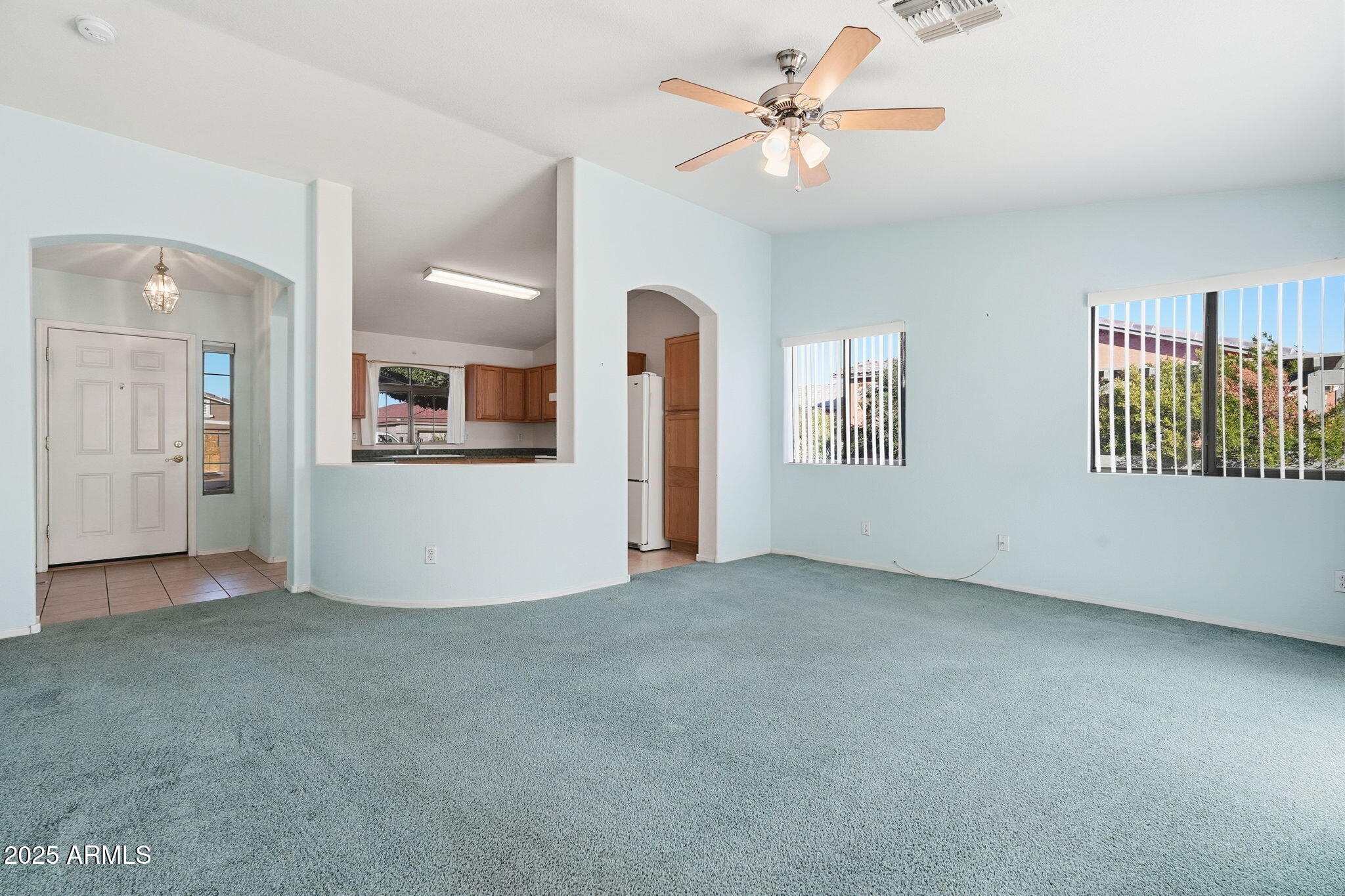 2101 South Meridian Road, Unit 354 Apache Junction, AZ 85120 - Photo 8 of 50 an empty room with fan and windows