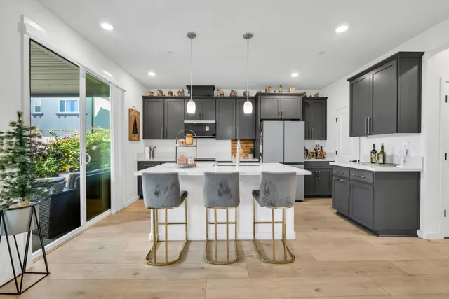 a kitchen with kitchen island stainless steel appliances a sink and cabinets