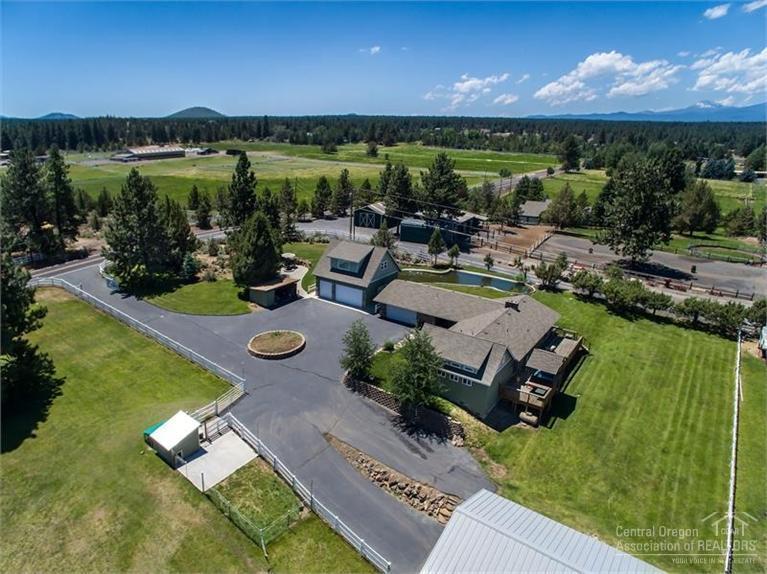 60366 Arnold Market Road Bend, OR 97702 - Photo 3 of 25 a view of a lake with lawn chairs and a big yard
