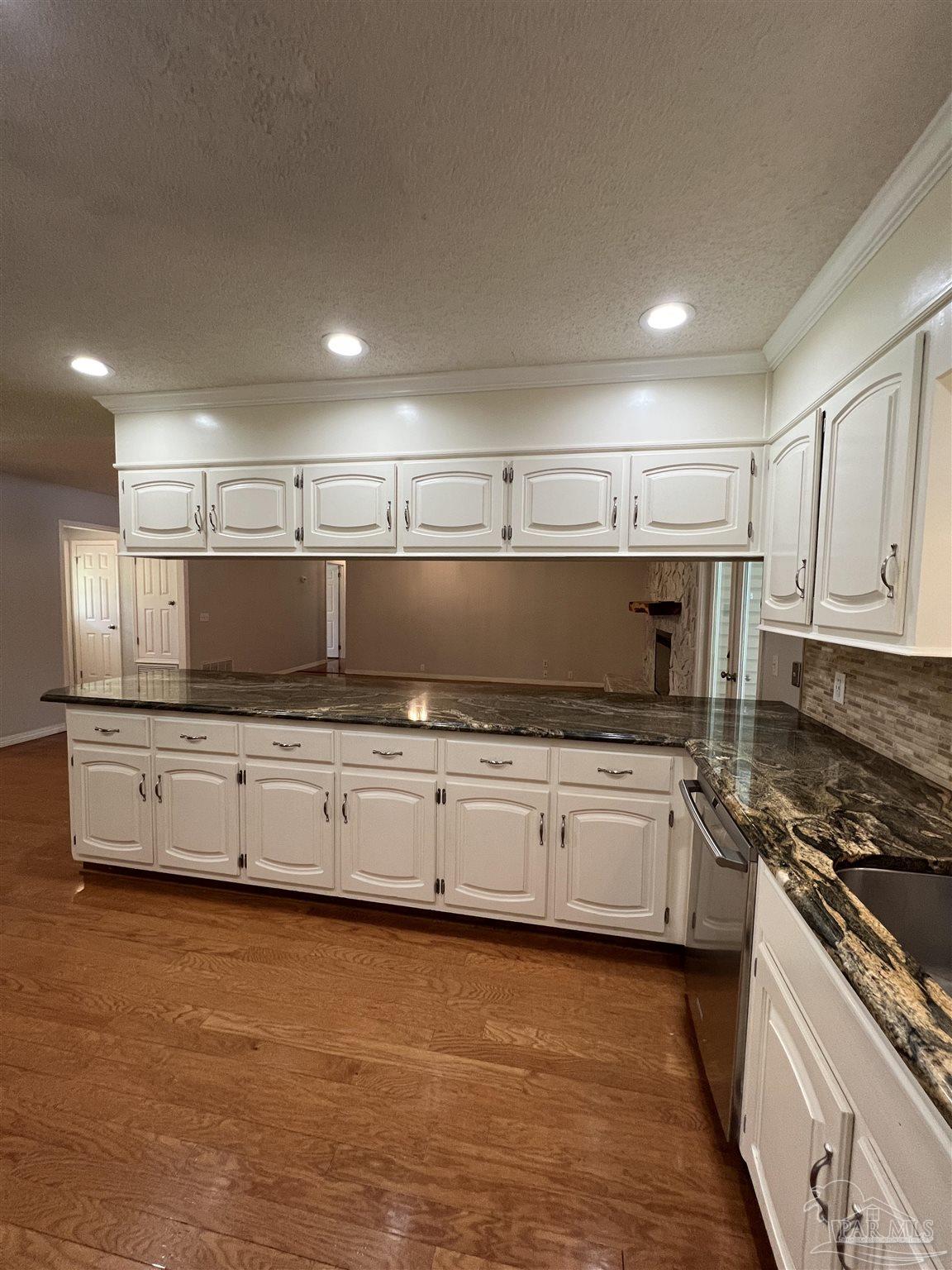 3143 Aarons Way Pace, FL 32571 - Photo 17 of 38 a kitchen with kitchen island granite countertop a stove and a sink