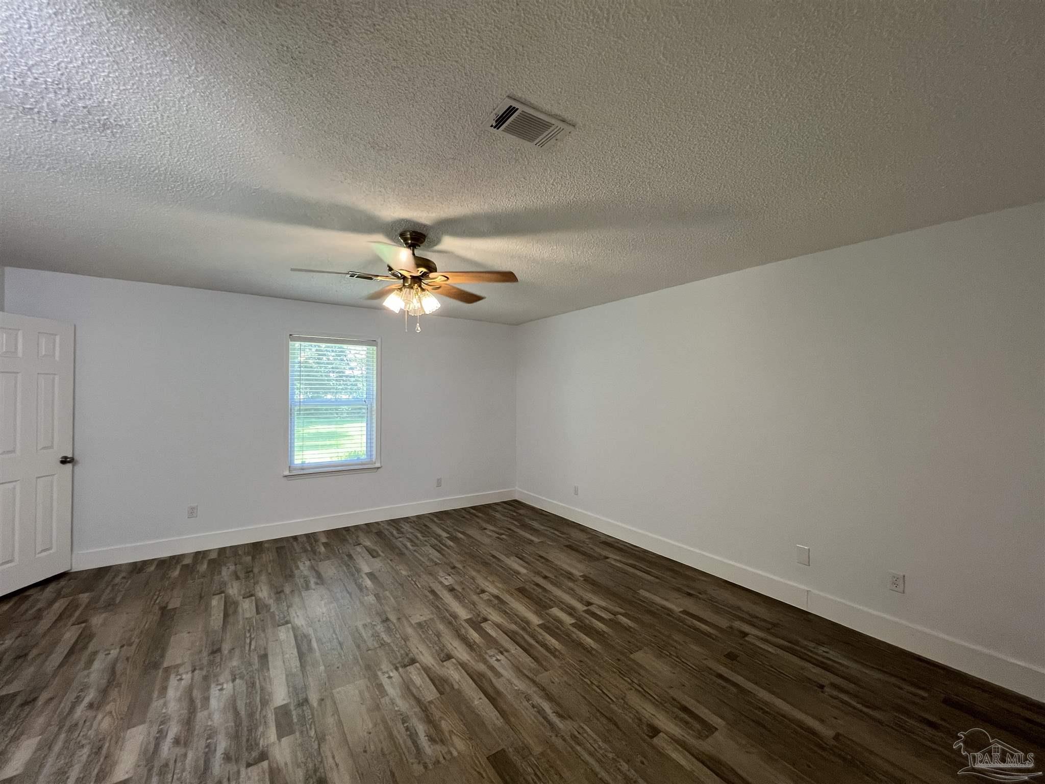 3143 Aarons Way Pace, FL 32571 - Photo 19 of 38 wooden floor in an empty room with a window