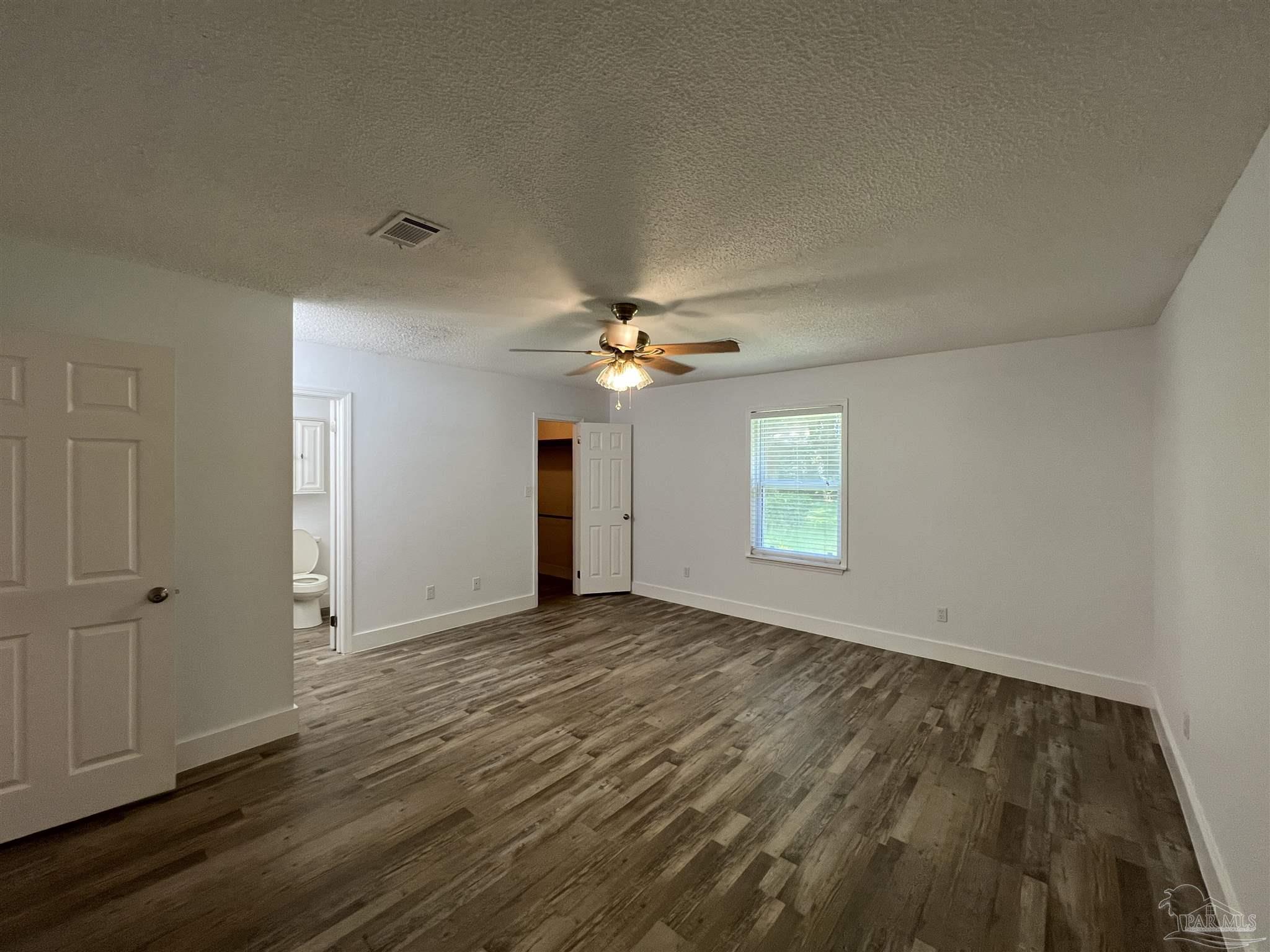 3143 Aarons Way Pace, FL 32571 - Photo 20 of 38 a view of empty room with wooden floor