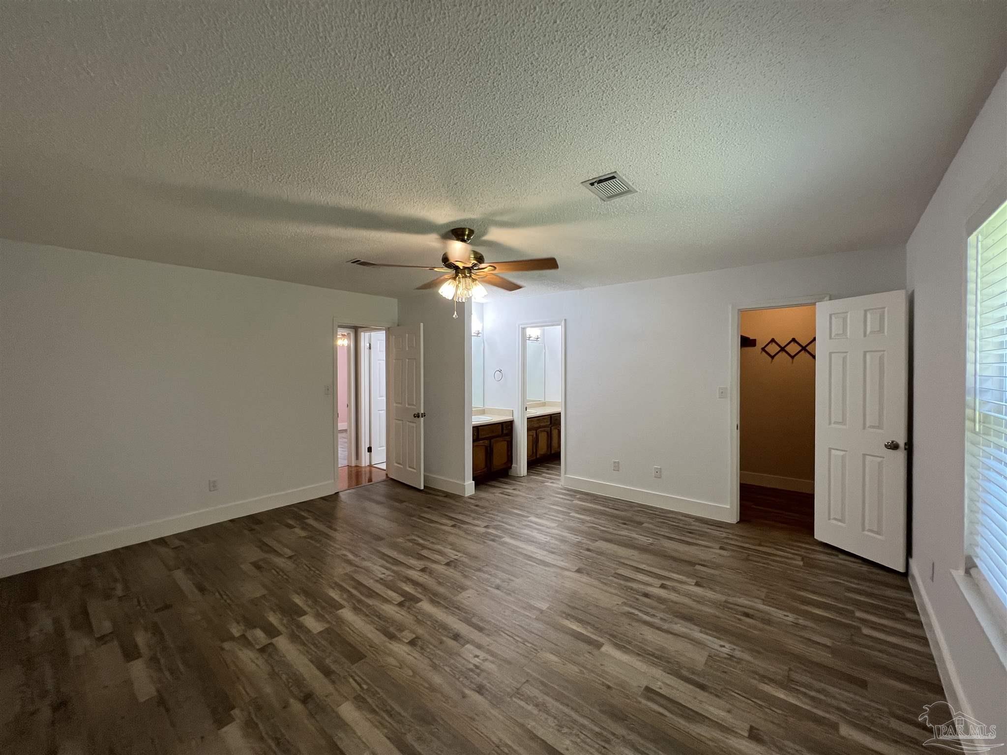 3143 Aarons Way Pace, FL 32571 - Photo 21 of 38 wooden floor in an empty room with a window