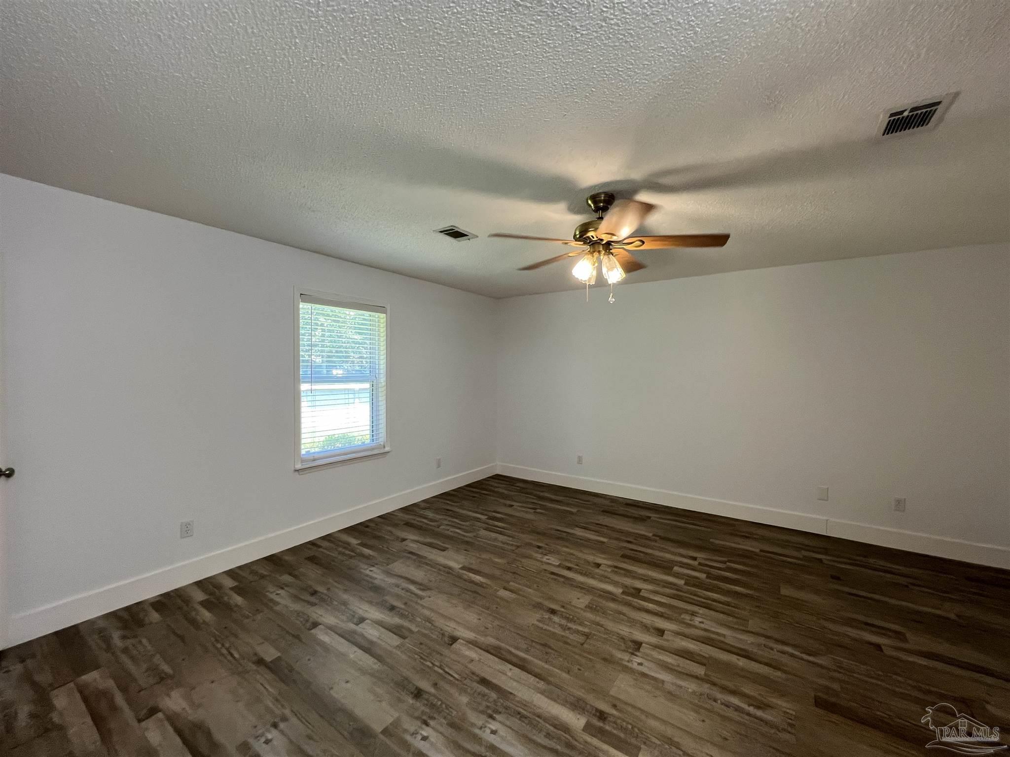 3143 Aarons Way Pace, FL 32571 - Photo 22 of 38 wooden floor in an empty room with a window