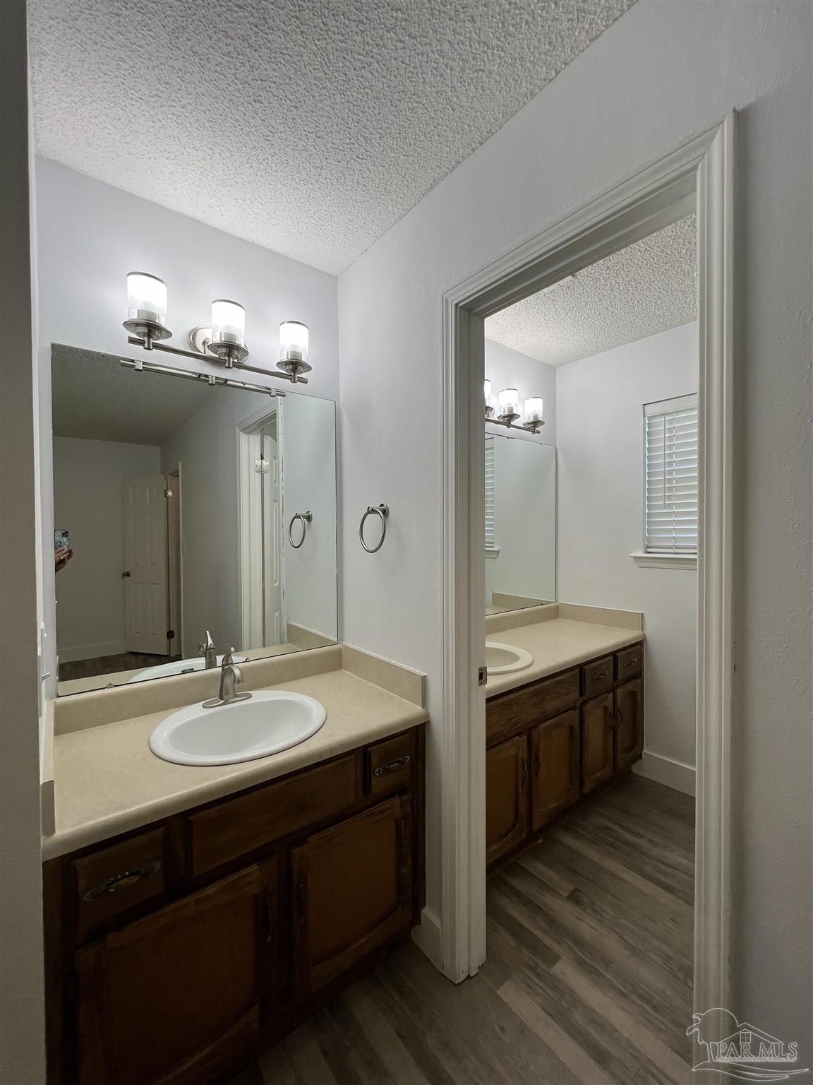 3143 Aarons Way Pace, FL 32571 - Photo 23 of 38 a bathroom with a double vanity sink and a mirror