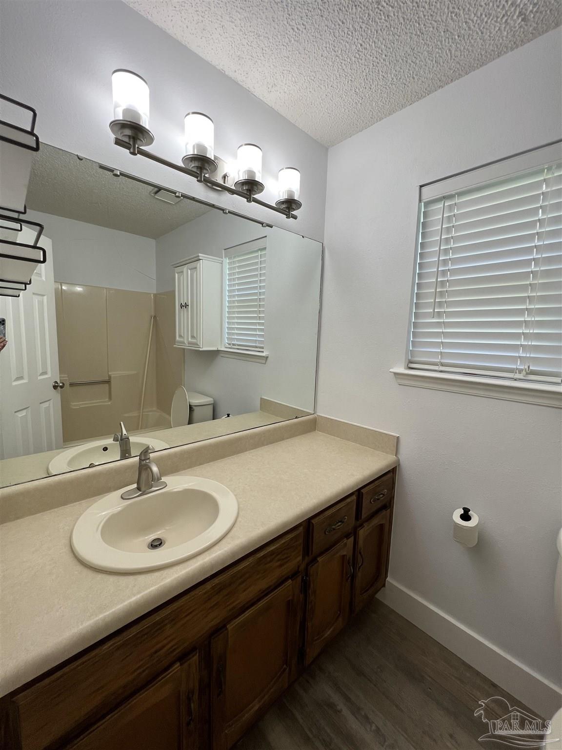 3143 Aarons Way Pace, FL 32571 - Photo 24 of 38 a bathroom with a sink and a mirror