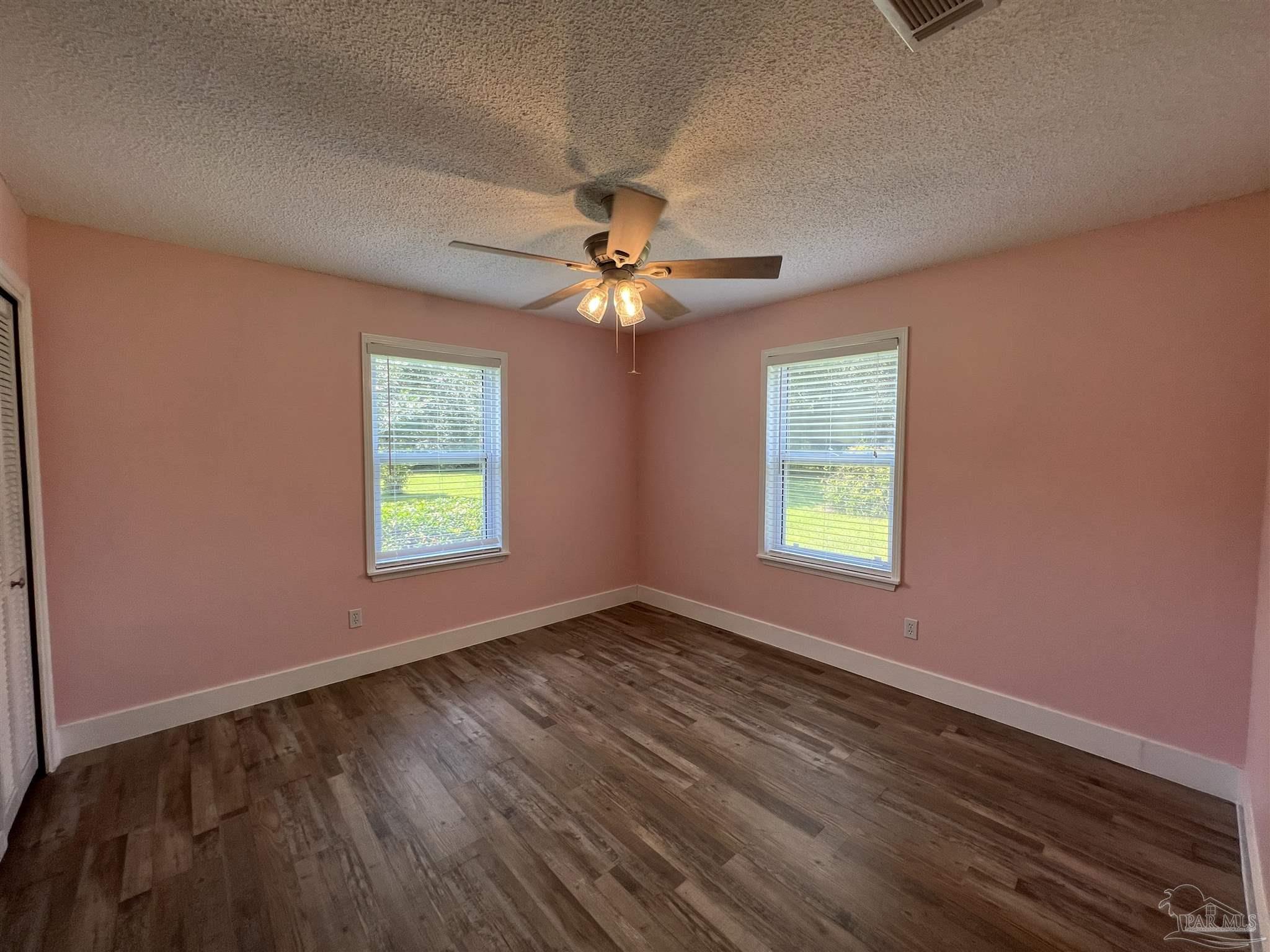 3143 Aarons Way Pace, FL 32571 - Photo 26 of 38 a view of an empty room with window and chandelier fan