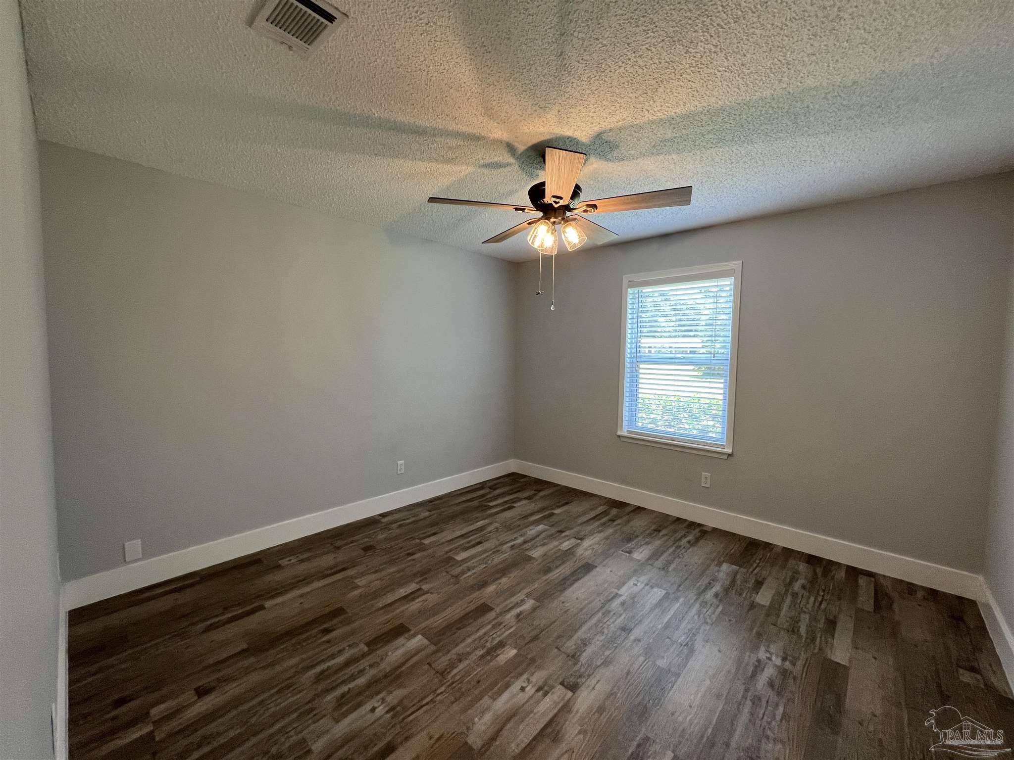 3143 Aarons Way Pace, FL 32571 - Photo 29 of 38 wooden floor in an empty room with a window