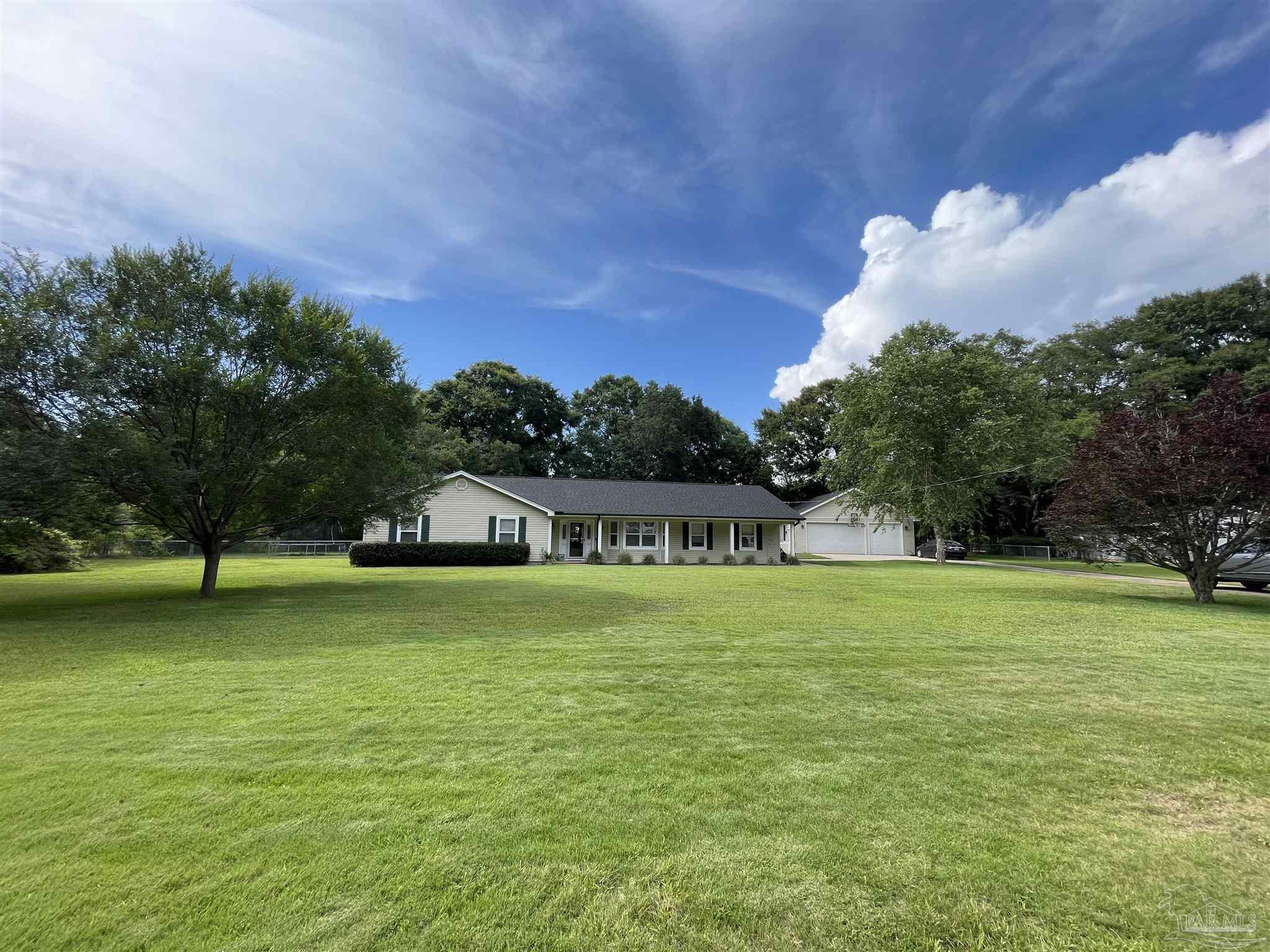 3143 Aarons Way Pace, FL 32571 - Photo 3 of 38 a fire hydrant in the middle of a field