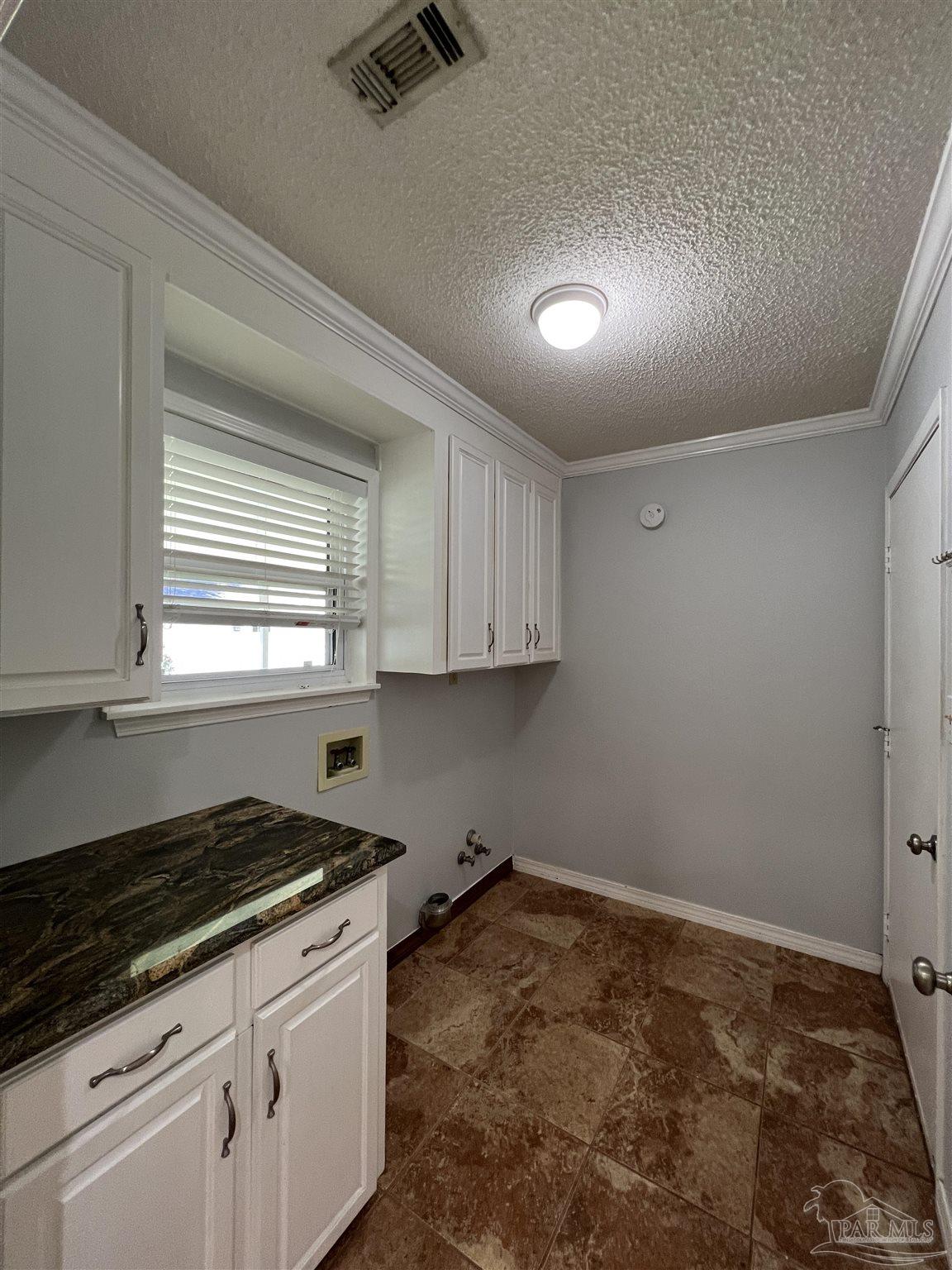 3143 Aarons Way Pace, FL 32571 - Photo 31 of 38 a kitchen with granite countertop a stove and white cabinets