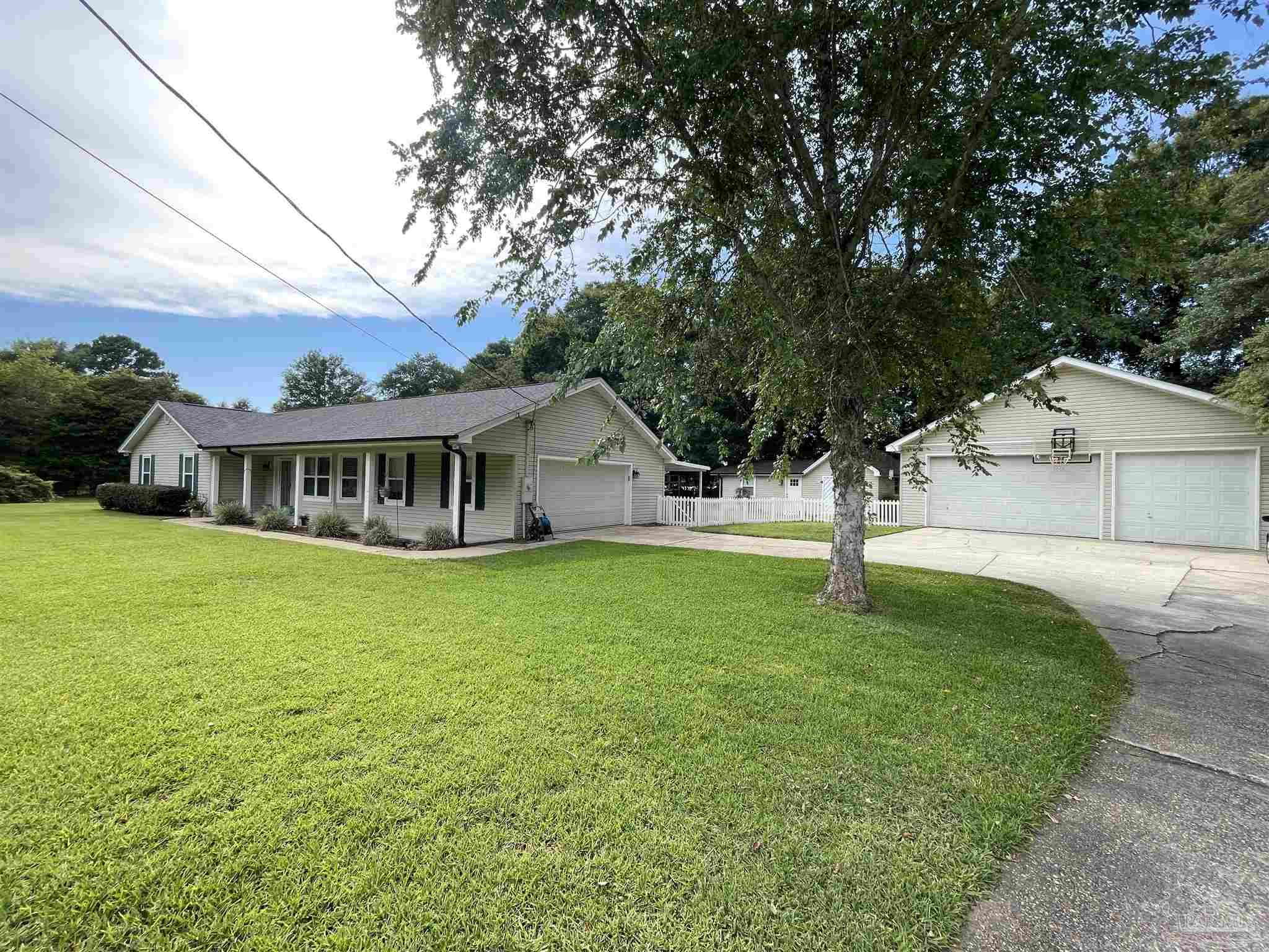 3143 Aarons Way Pace, FL 32571 - Photo 4 of 38 a front view of house with yard and trees
