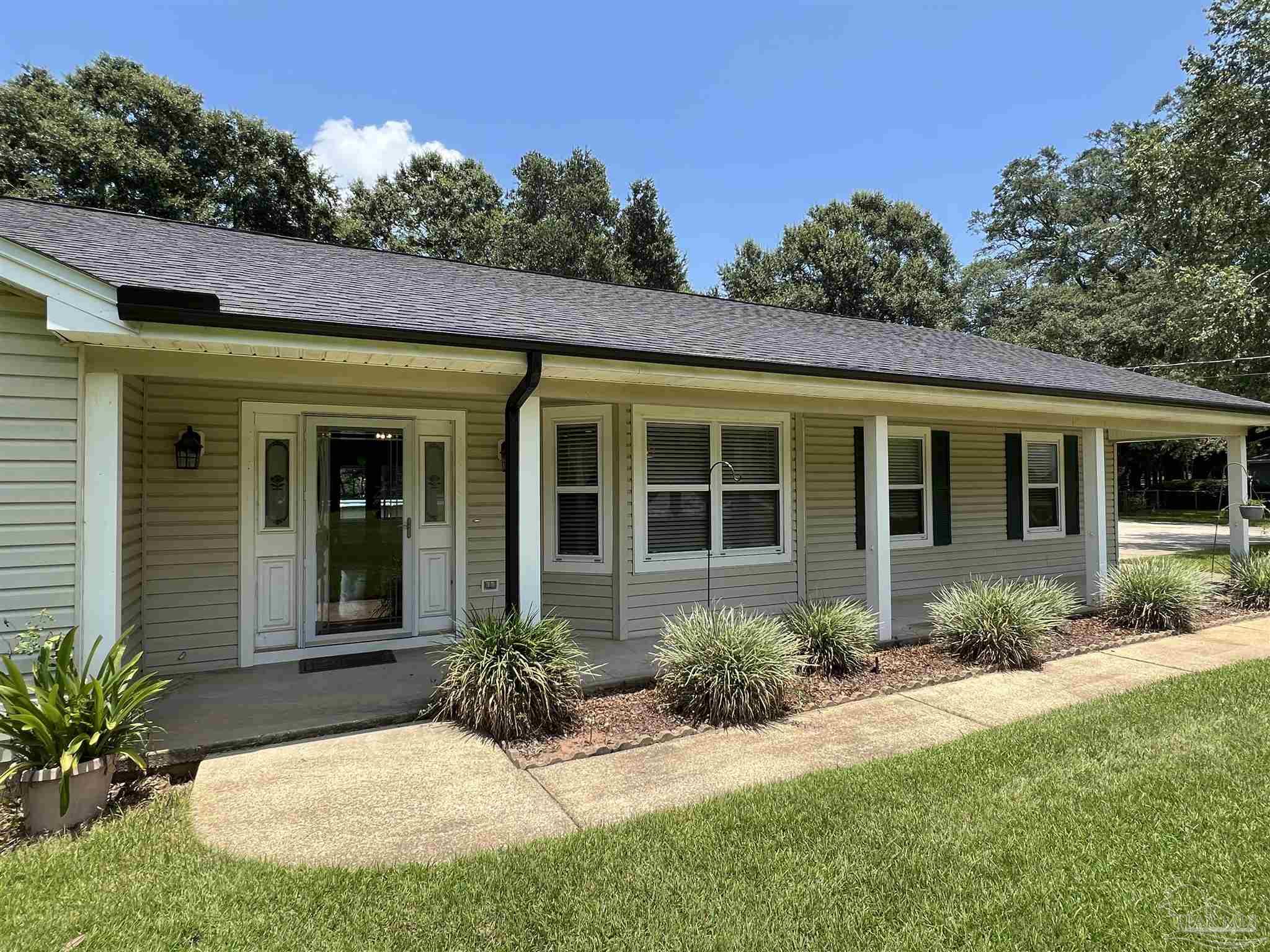 3143 Aarons Way Pace, FL 32571 - Photo 5 of 38 a view of a house with backyard and garden