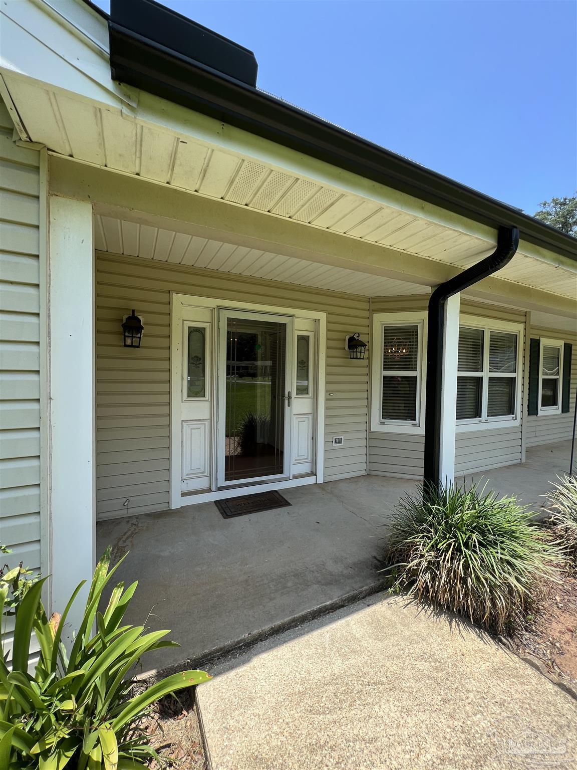 3143 Aarons Way Pace, FL 32571 - Photo 6 of 38 a front view of a house with a garden
