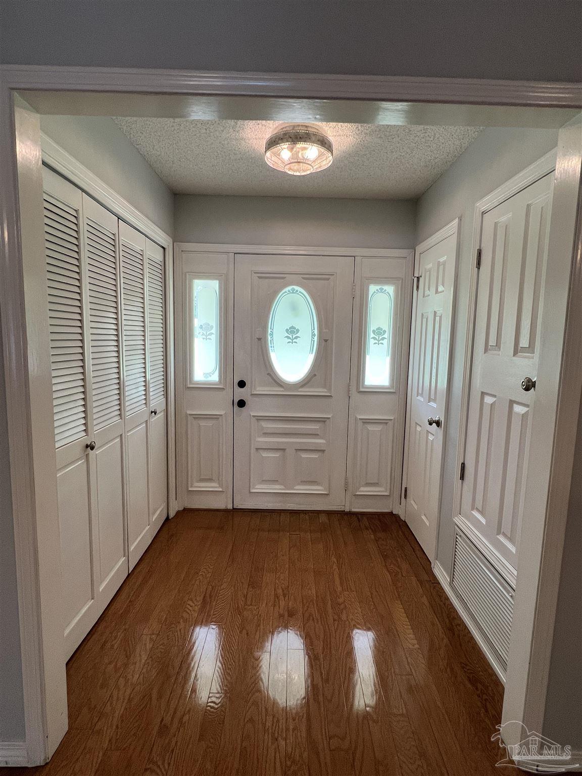 3143 Aarons Way Pace, FL 32571 - Photo 7 of 38 a view of a room with wooden floor and window