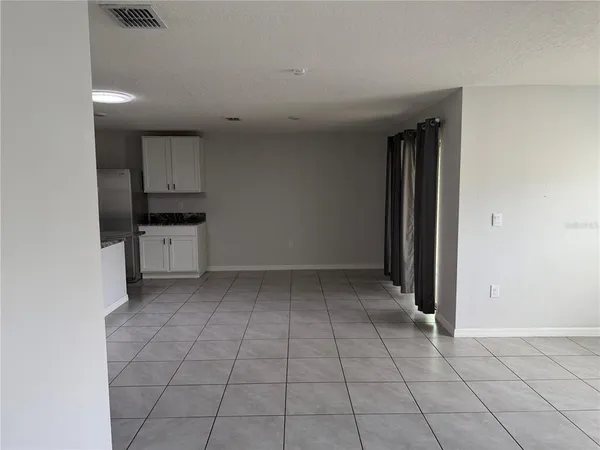a living room with granite countertop a sink and a window