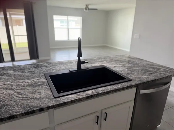 a stove top oven sitting inside of a kitchen