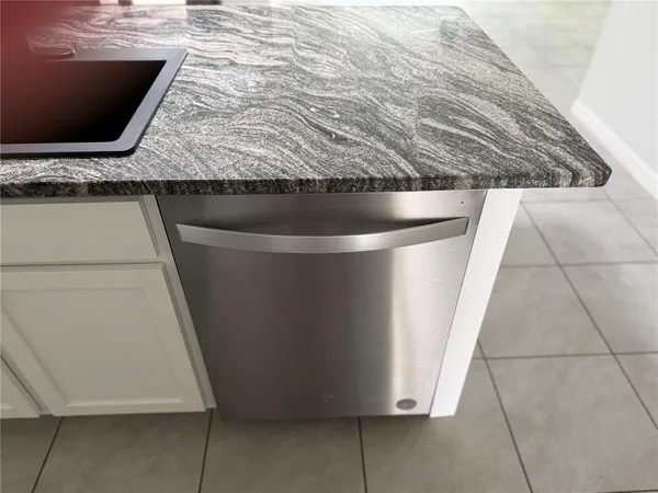 a kitchen with a refrigerator and cabinets