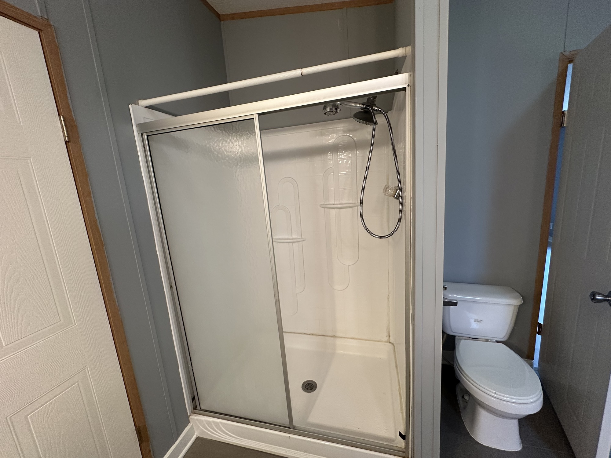 2229 Meekins Road Cleveland, TX 77328 - Photo 16 of 48 a bathroom with a granite countertop toilet and a glass door