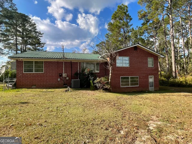 a house that has a tree in front of it