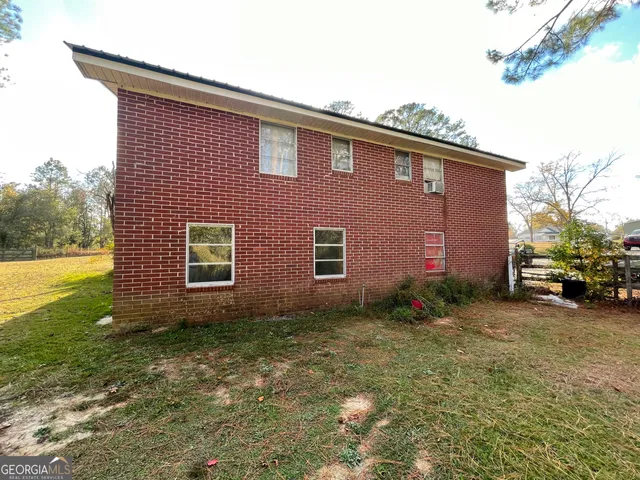 a brick building with a yard