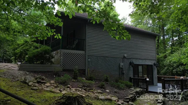 an aerial view of a houses with outdoor space and trees all around