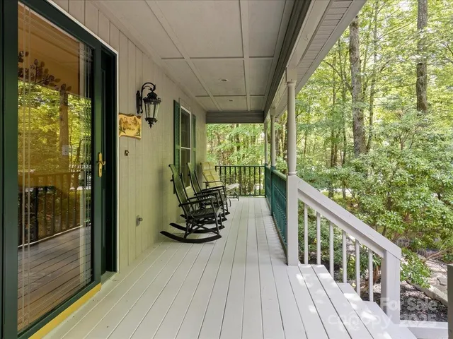 a view of balcony with wooden floor and fence