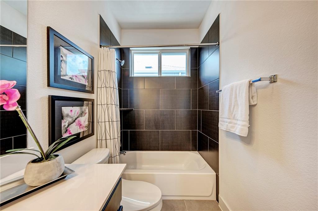 6006 Rubicon Run Austin, TX 78745 - Photo 17 of 22 a bathroom with a sink a toilet and a shower