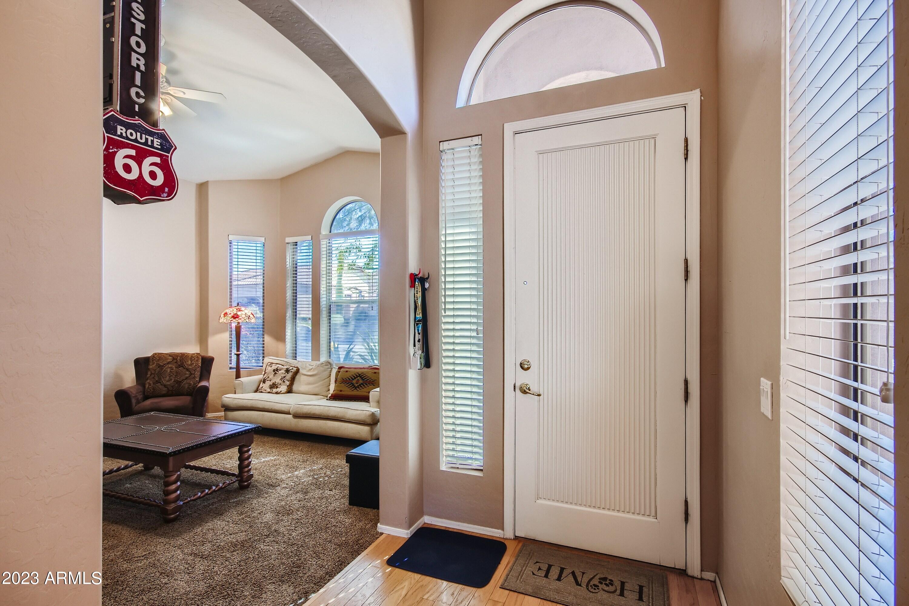 3060 North Ridgecrest, Unit 175 Mesa, AZ 85207 - Photo 4 of 28 a living room with furniture and a gate