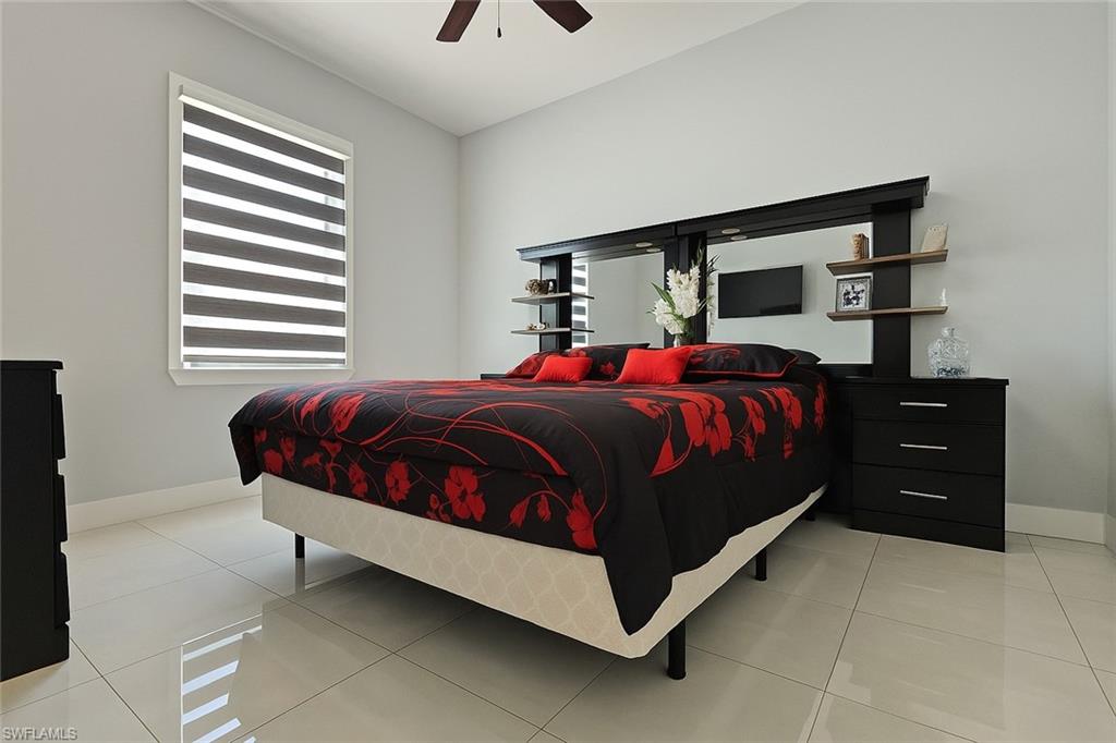 2330 4th Avenue Southeast Naples, FL 34117 - Photo 28 of 39 Bedroom featuring light tile patterned floors and a ceiling fan