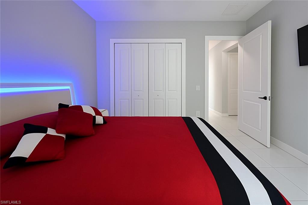 2330 4th Avenue Southeast Naples, FL 34117 - Photo 30 of 39 Bedroom with light tile patterned floors and a closet