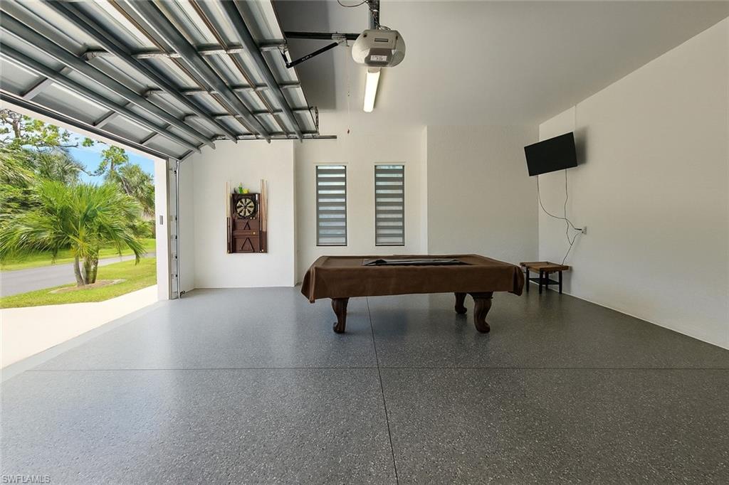 2330 4th Avenue Southeast Naples, FL 34117 - Photo 37 of 39 Playroom featuring a garage, pool table, and speckle patterned floor