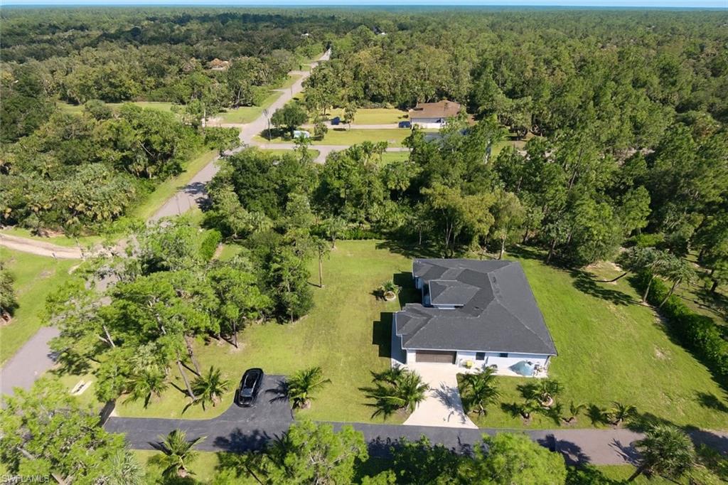 2330 4th Avenue Southeast Naples, FL 34117 - Photo 4 of 39 View from above of property featuring a forest